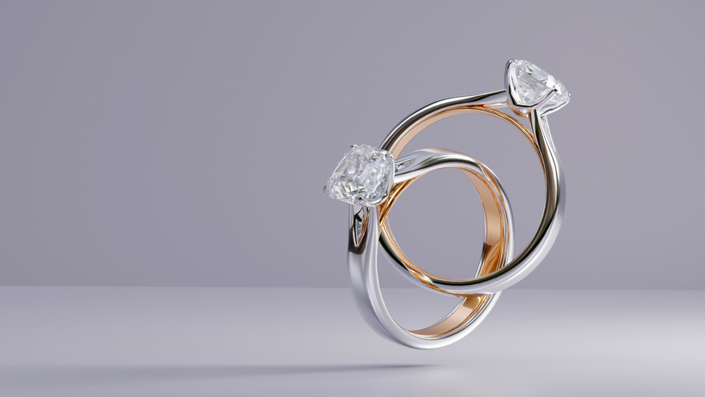 Platinum and gold ring with square diamonds floating on white background from design with 3d render