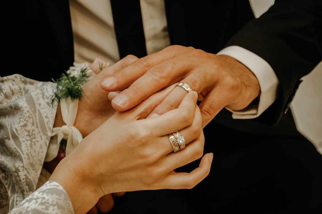 a couple exchanging wedding rings on the wedding day 
