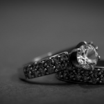 a black and white photo of two engagement rings